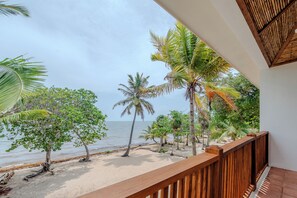 A balcony with a view of the beach and ocean.