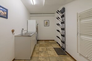 A compact kitchen with a sink, a small refrigerator, and a wine cooler.