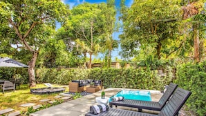 A backyard with a pool, outdoor furniture, and lush greenery. - Villa in the heart of design district! POOL+LOCATION (Miami)