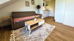 A modern apartment with a loft-style living area, a kitchenette, and a dining space. - Apartment at the Obersee (Bielefeld)
