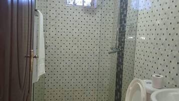 Standard Double Room | Bathroom | Shower, slippers, towels, soap