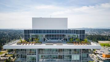 A modern building with a flat roof, large windows, and a flat facade.