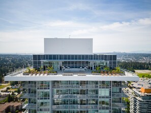 A modern building with a flat roof, large windows, and a flat facade. - Modern 2 Bed 2 Bath Condo with Parking, Patio & Amenities – Prime Location (Surrey)