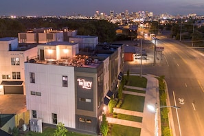A modern building with a rooftop bar and a sign reading "The Lucy."