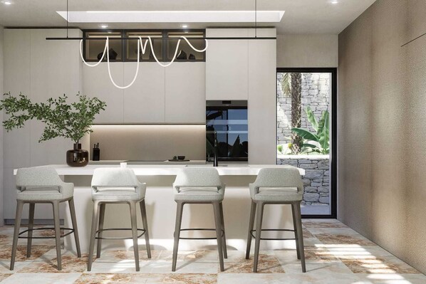 A modern kitchen with a bar area, a large window, and a potted plant.