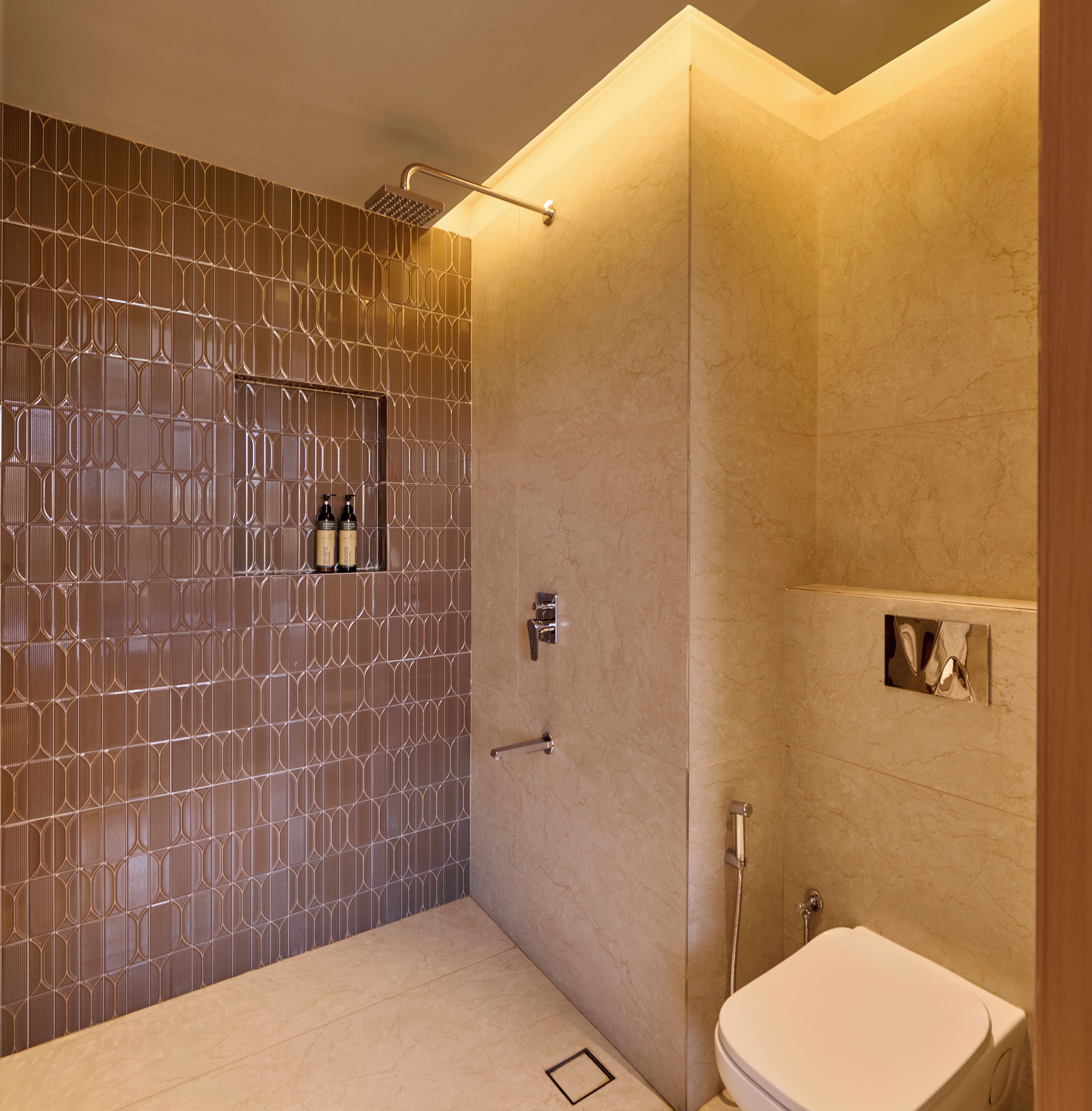 A modern bathroom with a patterned wall, a shower, and a toilet.
