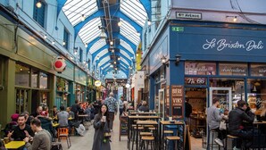 A bustling indoor market with a high, glass ceiling and various shops and eateries. - Exclusive 2 Bedroom Flat near Loughborough Junction! (Greater London)