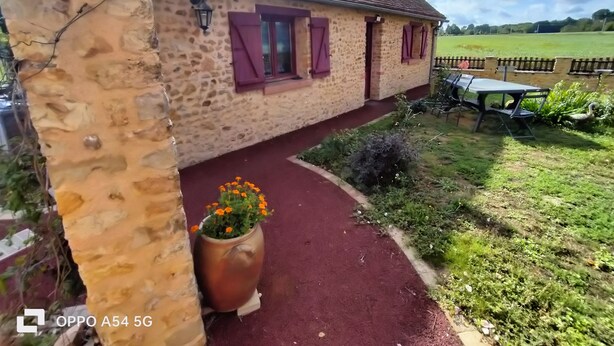 A stone building with a red pathway leading to a table and chairs outside. - Country house, close to footpaths, 5km base de loisirs, 15mn Zoo (Saint-Jean-de-la-Motte)