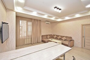 Apartment, 2 Bedrooms | Living area | 50-inch flat-screen TV with cable channels