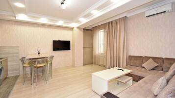 Apartment, 2 Bedrooms | Living area | 50-inch flat-screen TV with cable channels