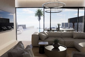 A modern living room with a large window, a sofa, a coffee table, and a dining area with a view of the ocean.