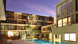 A multi-story hotel with a swimming pool, outdoor seating, and a well-lit courtyard. - Piazza on Church 906 by Ctha (Cape Town)