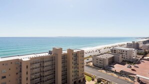 A coastal cityscape with high-rise buildings, a beach, and a clear sky. - Ocean View A1101 by Ctha (Cape Town)