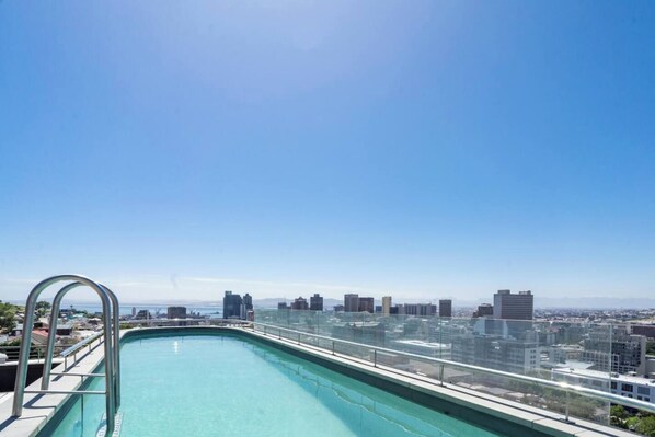 A rooftop pool with a city skyline view.