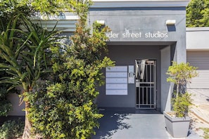 A building entrance with a sign reading 'Under Street Studios' and a mailbox with numbered slots.