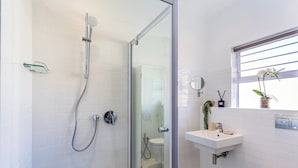 A modern bathroom with a glass-enclosed shower, a white sink, and a toilet. - Granada Court 309 by Ctha (Cape Town)
