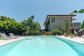 Seasonal outdoor pool, pool loungers