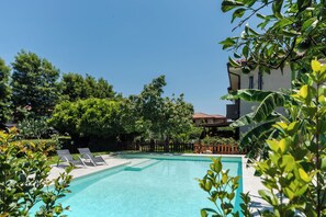 Seasonal outdoor pool, pool loungers