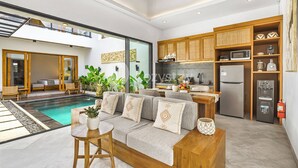 A modern kitchen with a built-in microwave, refrigerator, and water dispenser. - Oslen Villa by Kozystay - Canggu (Canggu)