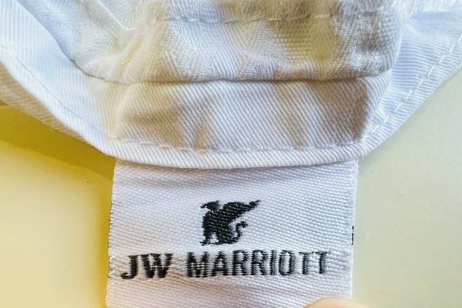 A white towel with a black embroidered logo and text 'JW MARRIOTT'.