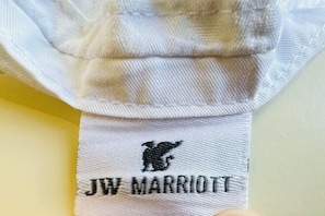 A white towel with a black embroidered logo and text 'JW MARRIOTT'. - Vancouver Love Home Luxury Inn (Richmond)