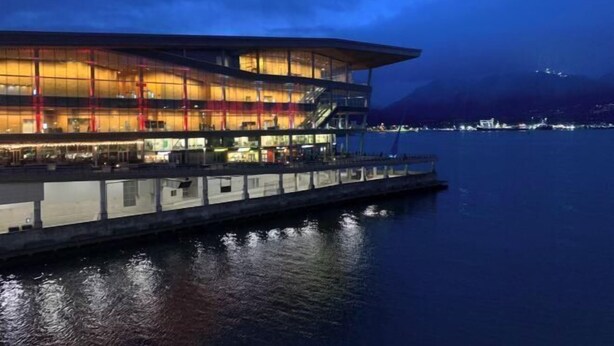 A waterfront building with multiple levels, large glass windows, and a flat roof. - Vancouver Love Home Luxury Inn (Richmond)