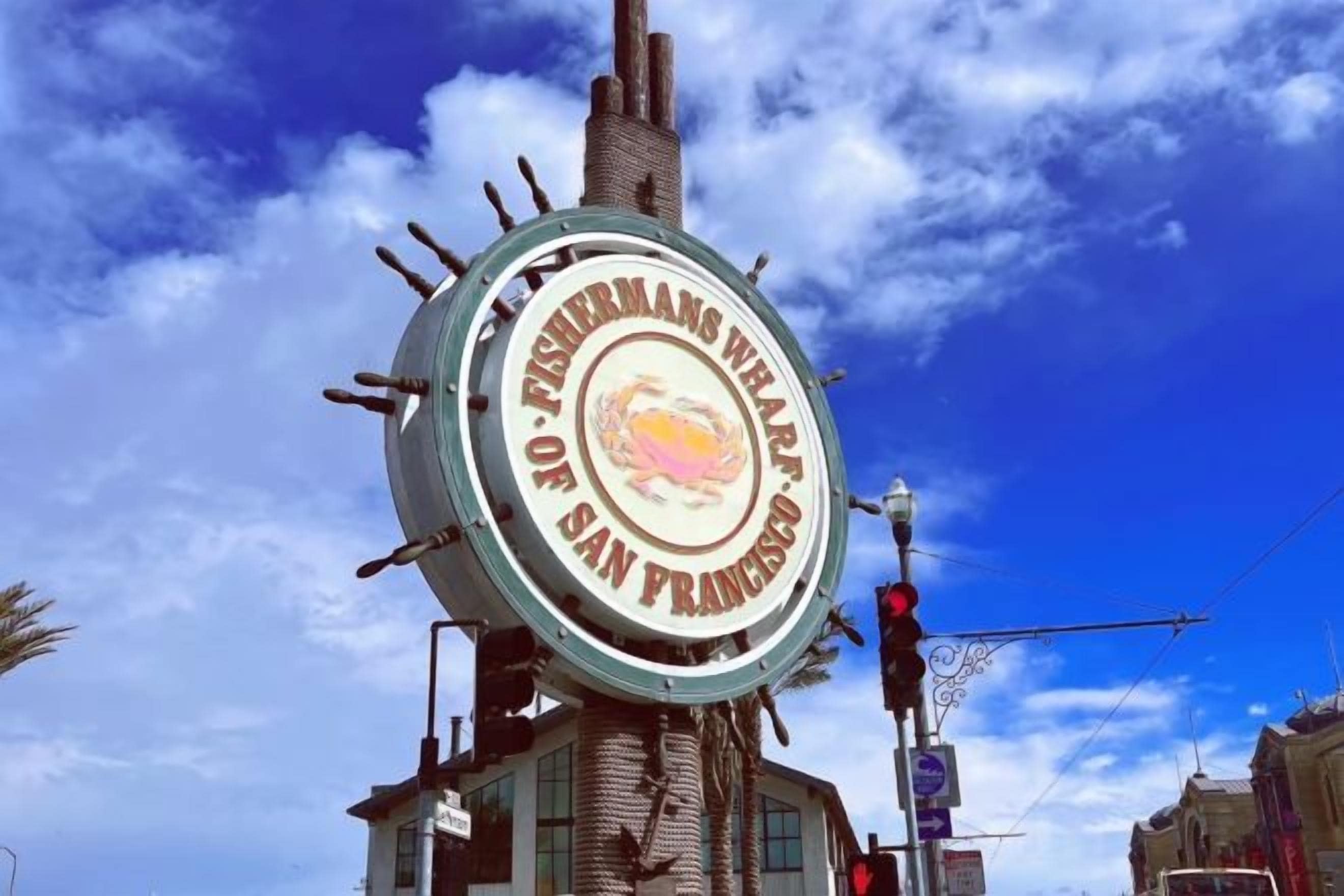 A circular sign with text, mounted on a pole, with a clear sky in the background.