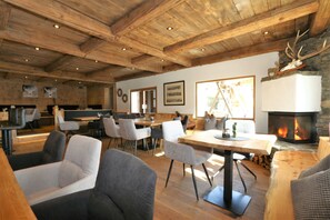 A rustic interior with wooden ceilings, a fireplace, and modern seating. - Unique Alpine Pasture in the Zillertal Mountains (Zellberg)
