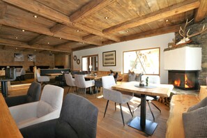 A rustic interior with wooden ceilings, a fireplace, and modern seating. - Unique Alpine Pasture in the Zillertal Mountains (Zellberg)