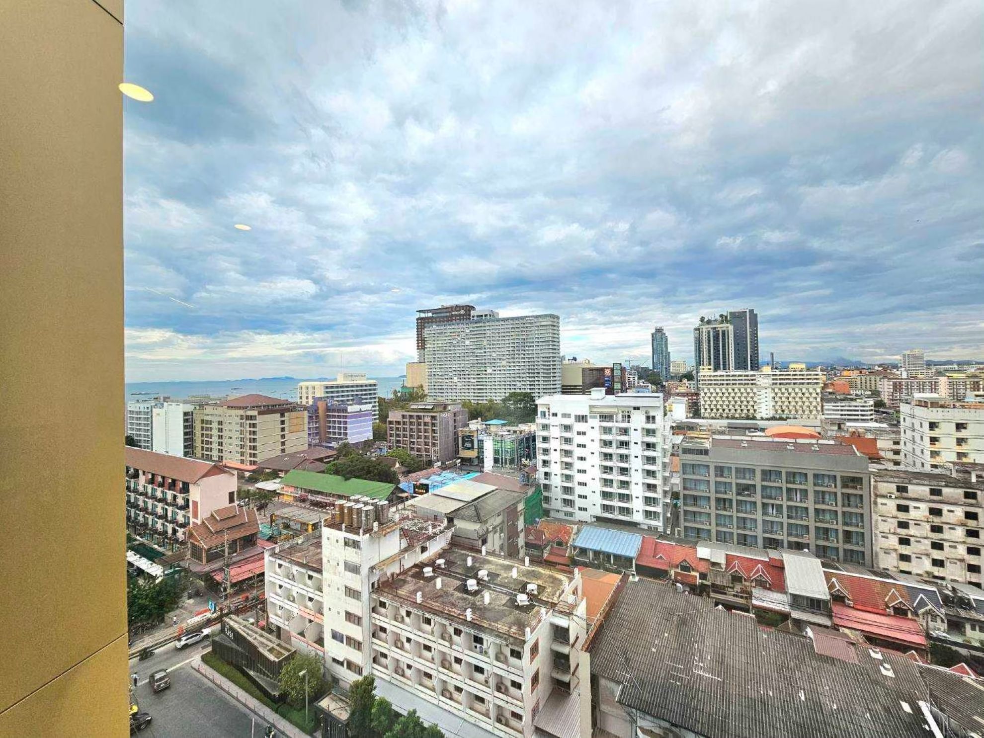 A cityscape with various buildings, including a prominent high-rise hotel with a modern design.