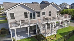 A two-story house with a balcony and a deck. - A Mindful Break | Private Pool | EV Charger | Full Gym (Surf City)
