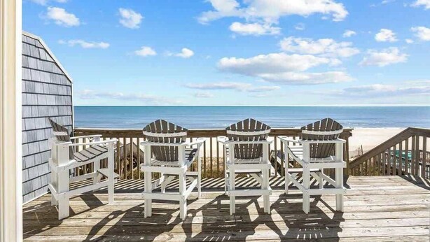 A wooden deck with white Adirondack chairs facing the ocean. - Oceanfront Retreat, Private Beach, Stunning Views (North Topsail Beach)
