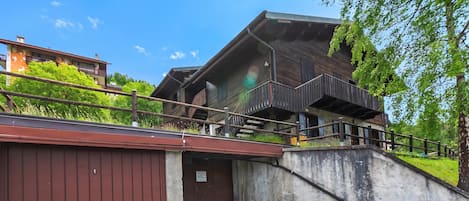 A two-story building with a wooden facade and a balcony.
