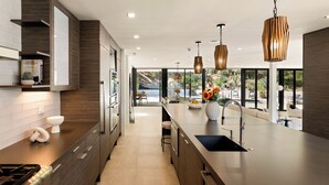 A modern kitchen with a large island, stainless steel appliances, and pendant lighting. - Valea Estate - Secluded Beverly Hills Retreat 1-acre Oasis (Beverly Hills)