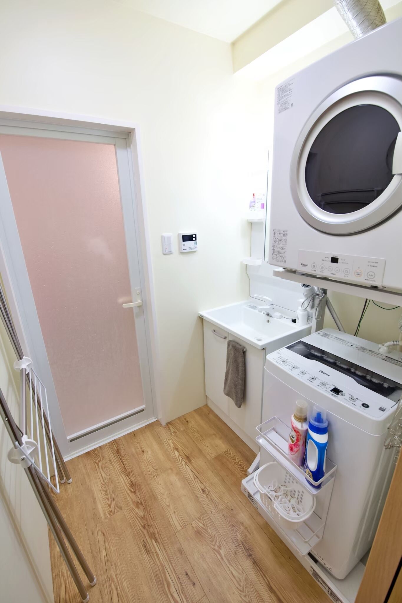 A compact laundry area with a washing machine, dryer, and a small sink.