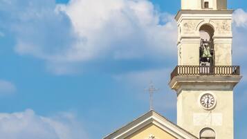 A church with a bell tower, a clock, and a dome.