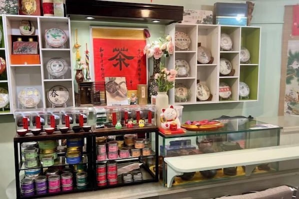 A display of ceramic dishes, a red sign with Chinese characters, and a glass case with items.