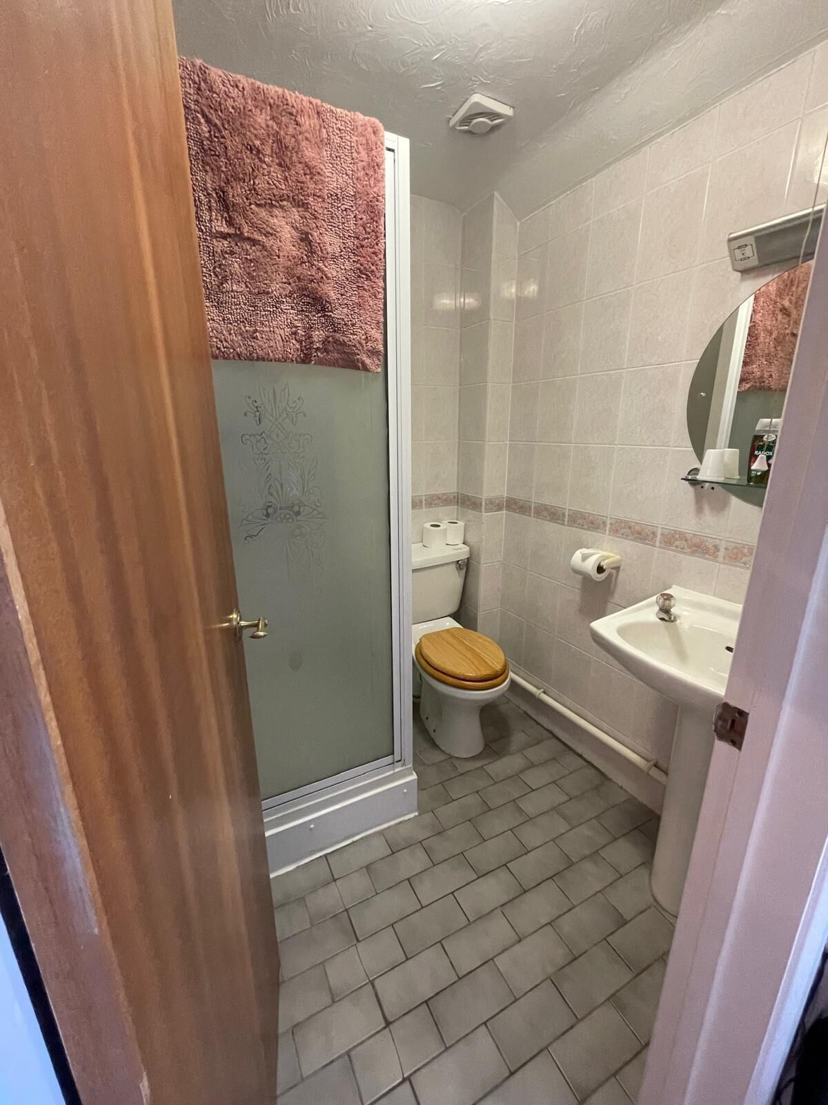 A bathroom with a toilet, sink, and shower.