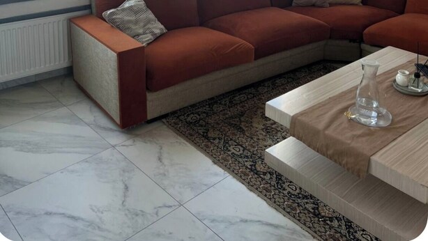 A modern living room with a large sectional sofa, a coffee table, and a view of the sea through large windows. - Dar sfar with sea view (Mahdia)