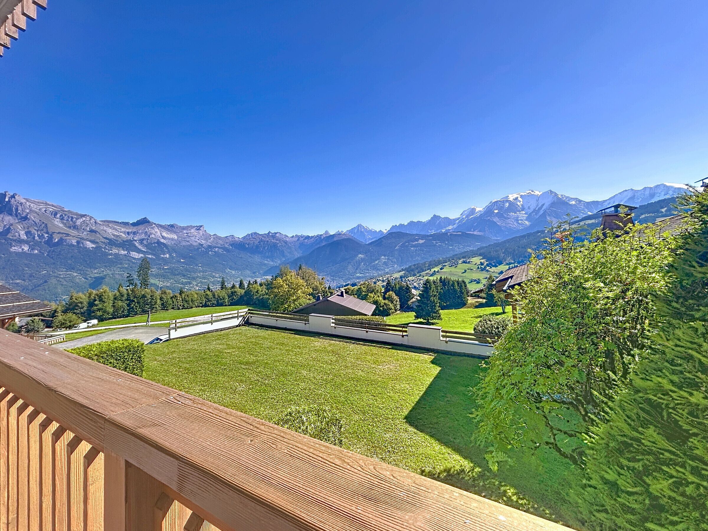 A view from a balcony overlooking a mountainous landscape with a clear sky.