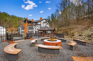 A traditional building with a fireplace and outdoor seating.