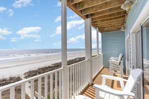 A wooden deck with white railings overlooking a beach. - Ambassador Villa 401-Oceanfront Penthouse,End Unit (North Myrtle Beach)