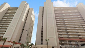 Two high-rise buildings with multiple balconies, likely part of a hotel or residential complex. - Crescent Shores 807 Oceanfront, Pools, Lazy River (North Myrtle Beach)