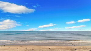 A beach with clear skies and calm waters. - Crescent Shores 810 Oceanfront, Pools, Lazy River (North Myrtle Beach)