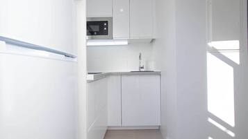 Comfort Apartment, Garden View | Private kitchen | Full-size fridge, microwave, stovetop, cookware/dishes/utensils