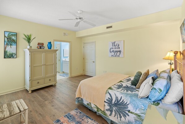 A bedroom with a bed, a dresser, a ceiling fan, and a door leading to another room. - Margate 2109 in Kingston, Oceanview, Pool, Beach (Myrtle Beach)
