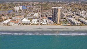 An aerial view of a coastal city with a beachfront hotel, high-rise buildings, and a sandy beach. - A Place at the Beach A105 New flooring Oceanfront (Myrtle Beach)
