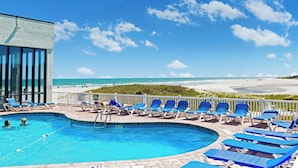 A pool area with lounge chairs and a view of the beach. - Sands Beach Club 814, End Unit Sunsets & Pools (Myrtle Beach)