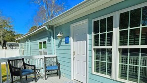 A house with a porch, two chairs, a table, and a door. - Drift Away with Inlet Vibes in Murrells Inlet at a Peaceful Studio (Murrells Inlet)