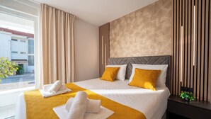 A hotel room with two beds, a large window, and a view of the outside. - Relax apartment with private pool I (Novalja)